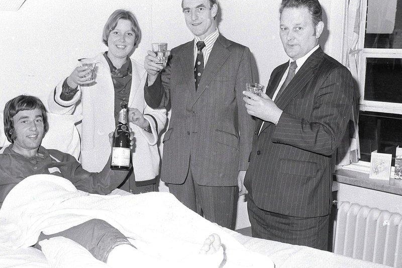 Barry Foster celebrates promotion in his hospital bed after breaking his leg in 1977.