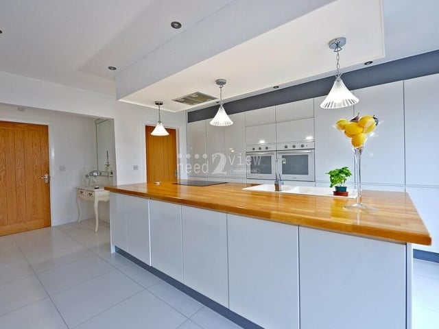 The units in the kitchen are complemented by co-ordinating, wooden roll-top work surfaces, with a one-and-a-half bowl single-drainer sink and chrome mixer tap.