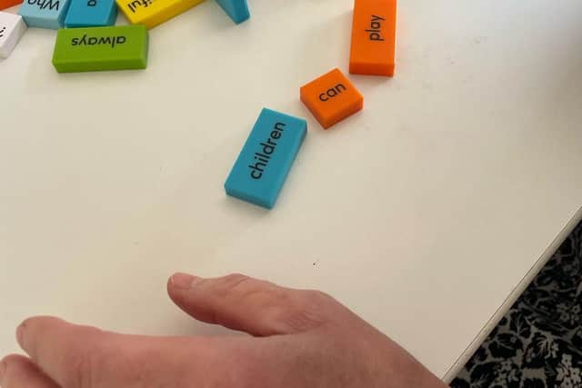 Creative arts therapist using word blocks to make sense of feelings