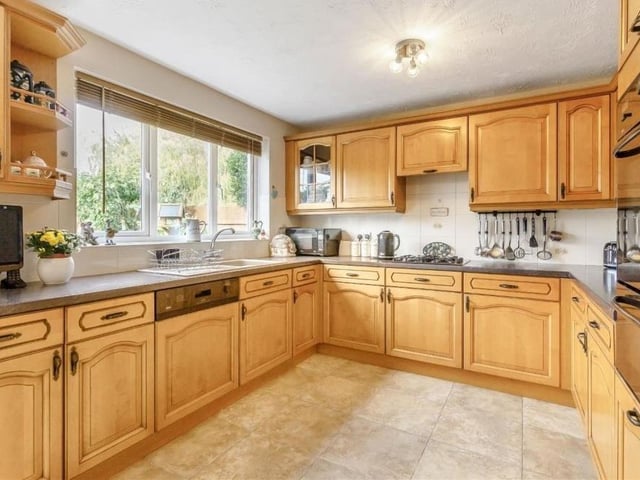 Here is our first look at the breakfast kitchen, which is fitted with a range of wall cupboards, base units and drawers with work surfaces above. Integrated appliances include a double oven, four-ring gas hob and extractor hood above, and dishwasher.