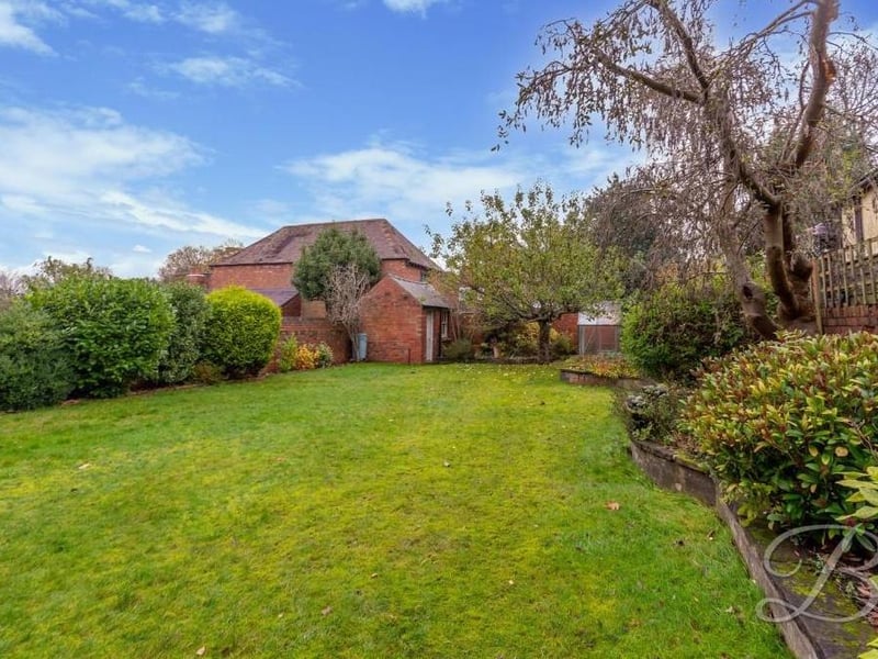 The back garden is well maintained, with a large lawn, planted borders, mature shrubs and fruit trees. There is also an outbuilding with power.