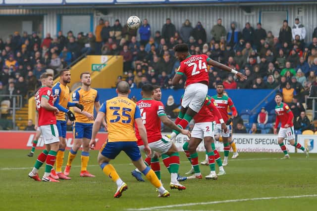 Rollin Menayese heads clear against his former club for Walsall on Saturday. Photo by Chris Holloway / The Bigger Picture.media