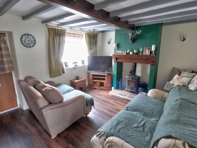 The composite front door (left) opens into the lounge, which is very much the hub of the house, with a door to the staircase, a door to an under-stairs cupboard and also access to the dining kitchen. A double-glazed window facing the front of the cottage lets in plenty of natural light.