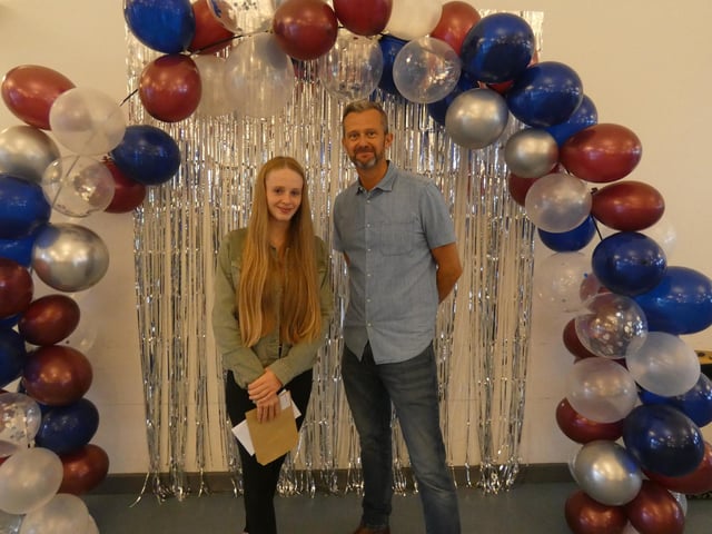 Grace Kennedy, who achieved a Grade 7 or above in all ten of her GCSEs, with Chris Woollard, headteacher