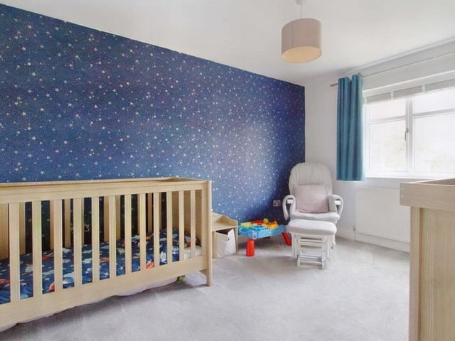 The fourth bedroom, currently being used as a child's room, is well proportioned, with a carpeted floor and views of the garden.