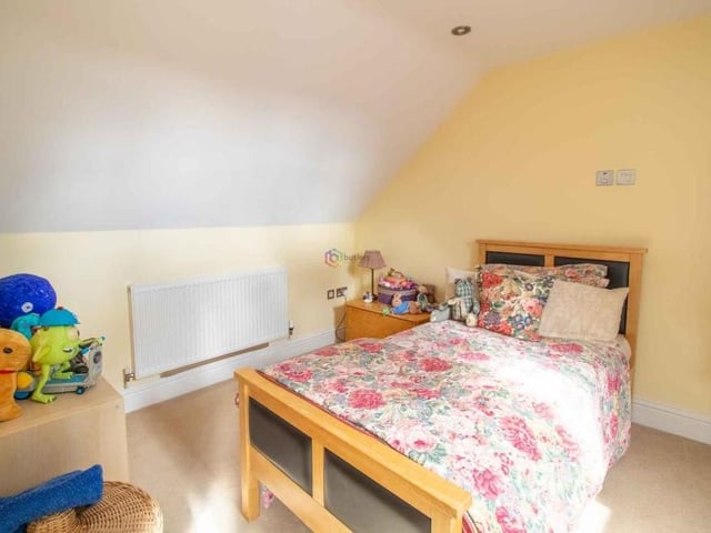 The sixth and final bedroom at the Sutton property is another attic room. It is fitted with a Velux window, and there is storage in the eaves.