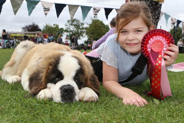 Deanna Harrison with handsome St Bernard puppy Riggs, who won the event's dog show.