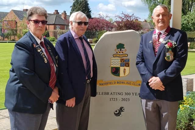 Vice president Dawn Wood, QE Endowed Trust's John Carter, and president Trevor Livings with the stone.