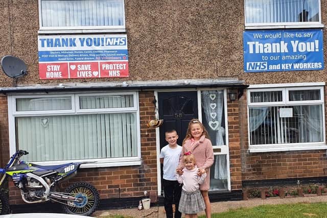 Daisy Lamb and her family decorated their house with banners.
