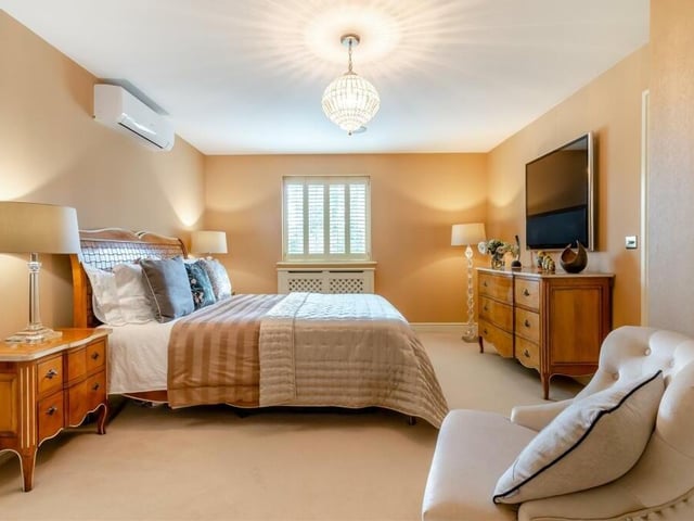 The master bedroom is a terrific size and has access to both a dressing room and an en suite shower room. An added bonus during the summer is a Fujitsu air-conditioning unit.