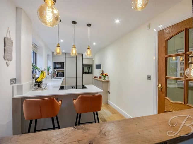 The kitchen features a brand new breakfast bar/island and an open hatch looking through to the living room, with windows to the rear elevation allowing plenty of natural light.