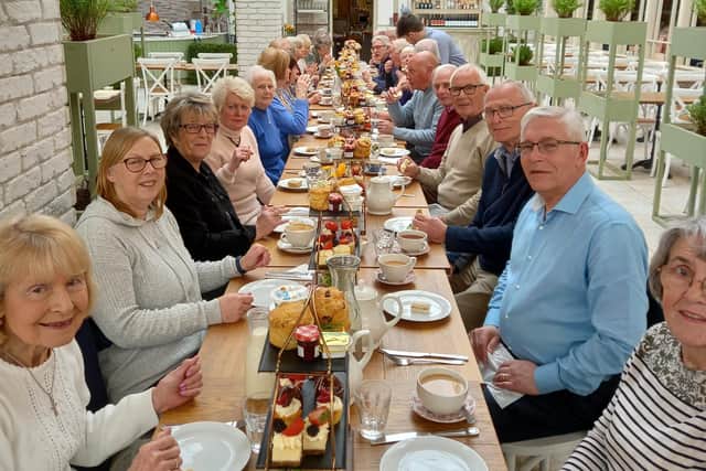 Club members and their families enjoy an afternoon tea.
