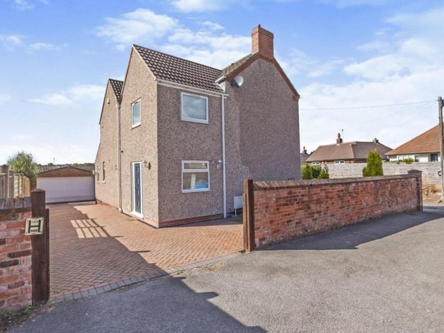 Time to step outside now, and this photo shows the driveway at the side of the property which provides off-street parking space and leads to a detached garage.
