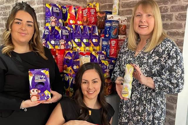 Salon owner Hayley Wood (right), manager Alanya Jennings (centre) and staff member Beth McLane with some of the Easter eggs donated to Wood's of Westgate.
