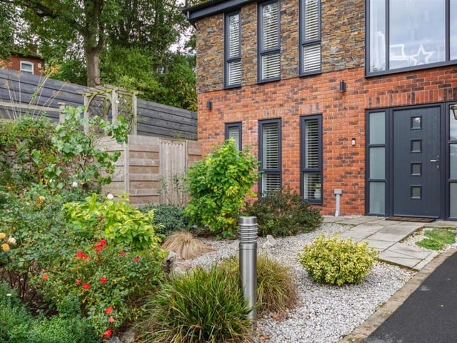 As we say farewell to the Rockcliffe Gardens property, here's the low-maintenance front garden, with gravel, mature shrubs and paved pathway.