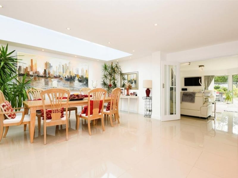 The double doors in the sitting room lead seamlessly into this dining room, which is also part of the open-plan living scheme. It is bright, thanks to its recessed spotlights, and spacious.