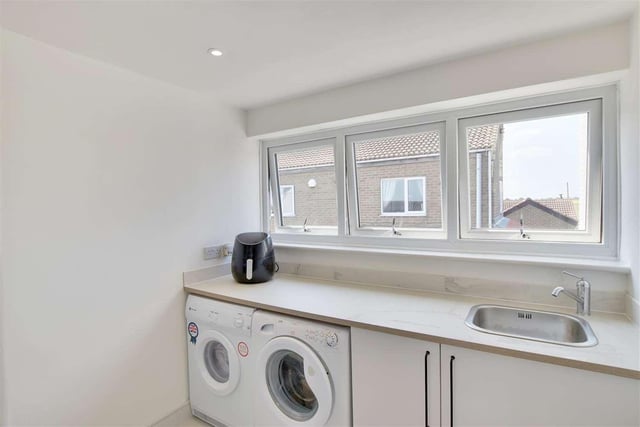 A small utility room comes with fitted base units, a work surface and sink. A washing machine, tumble dryer and fridge freezer are also included.