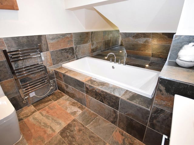 The immaculate, modern decor, which can be found throughout Moles End, stands out in the family bathroom, which has been recently fitted. It offers a double-ended bath with shower fittings, a wash basin in a double-drawer vanity unit, a low-flush WC, a chrome heated towel-rail and a tiled floor with underfloor heating.