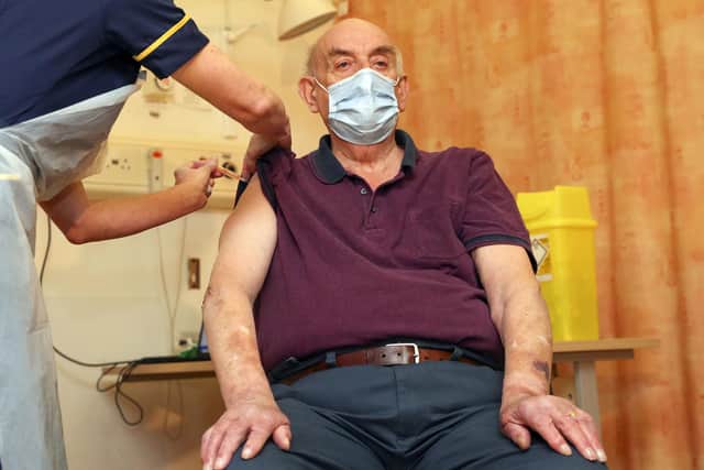 Brian Pinker, 82, receives the AstraZeneca Plc and the University of Oxford Covid-19 vaccine from nurse Sam Foster at the Churchill Hospital in Oxford.