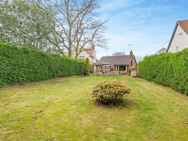 A long look down the well-maintained lawn at the back of the Sutton bungalow. As you can see, the garden is enclosed and private.