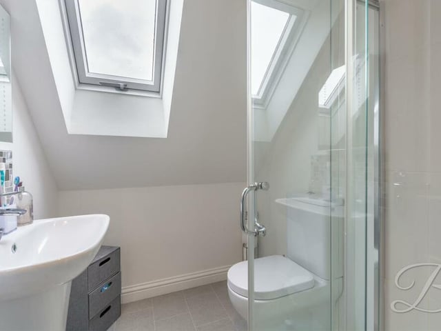 The en suite to the master bedroom is fitted with a walk-in shower cubicle, low-flush WC, hand wash basin and Velux window to the back of the bungalow.