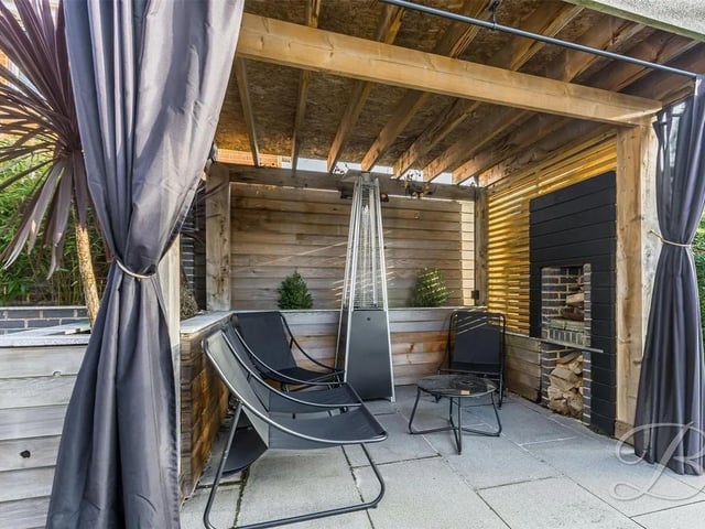 The garden features a charming wooden pergola complete with a log burner, and a stunning patio area, perfect for family gatherings and alfresco dining.