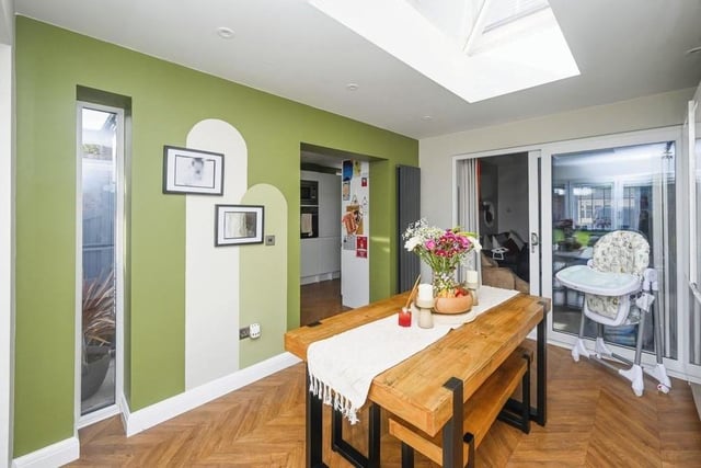 Here are those sliding doors that lead from the second reception room into this dining room. It is an ideal space for family meals or for entertaining friends -- and a bright one too thanks to a roof lantern.