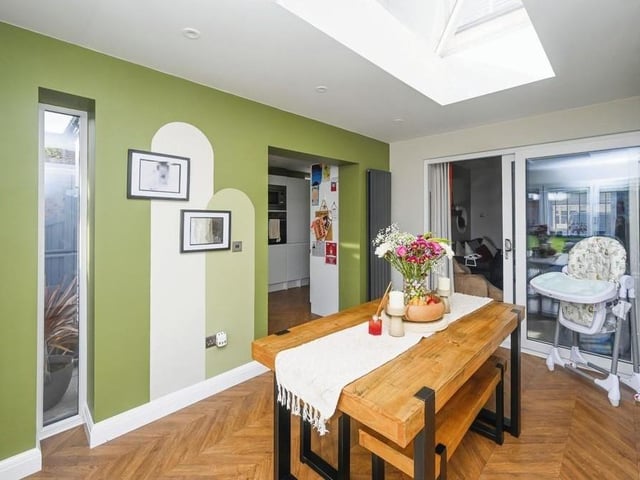 Here are those sliding doors that lead from the second reception room into this dining room. It is an ideal space for family meals or for entertaining friends -- and a bright one too thanks to a roof lantern.