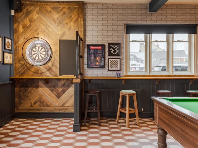 The pub has regulation dart boards and pool tables