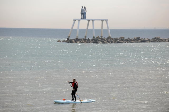Paddle boarder out on the water.