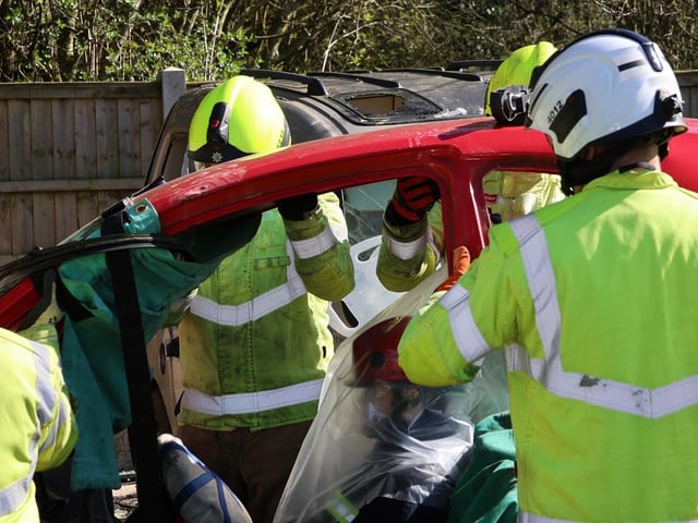 Casualty extraction - Firefighters cut the roof off the car and got the casualties from the vehicle. Images Paul Horton