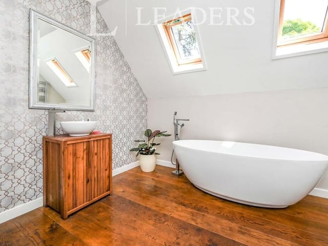 Like the master, bedroom number five has its own en suite. It consists of a white four-piece suite, with free-standing bath, low-level WC, wash hand basin and corner shower enclosure. There are also a chrome, heated towel-rail, spotlights, solid oak flooring and two sky lights to the ceiling.