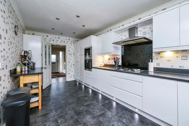 The modern kitchen, complete with stunning vinyl floor and tiled walls, is fitted with a range of wall and base units, plus work surfaces over. There's an integrated gas hob with cooker hood over, as well as plenty of space for a breakfast bar or table.