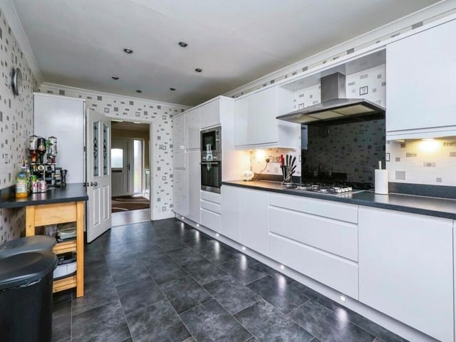 The modern kitchen, complete with stunning vinyl floor and tiled walls, is fitted with a range of wall and base units, plus work surfaces over. There's an integrated gas hob with cooker hood over, as well as plenty of space for a breakfast bar or table.
