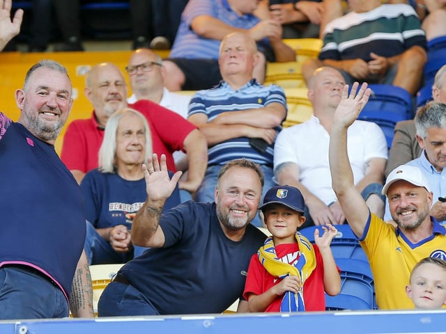 Mansfield Town fans watch the Carabao Cup first round match against Derby County.