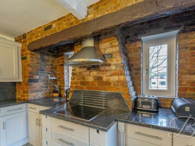 As you can see, although the kitchen is contemporary, with modern appliances, it has a traditional twist too, thanks to open-brick features and beams.