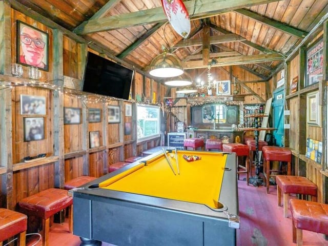 The interior of the games room has the wow factor, doesn't it? Its 11-foot high vaulted ceiling is the highlight, along with a log-burner. The bar is at the far end and there is space for seating and a pool table. The whole room is equipped with power and light.