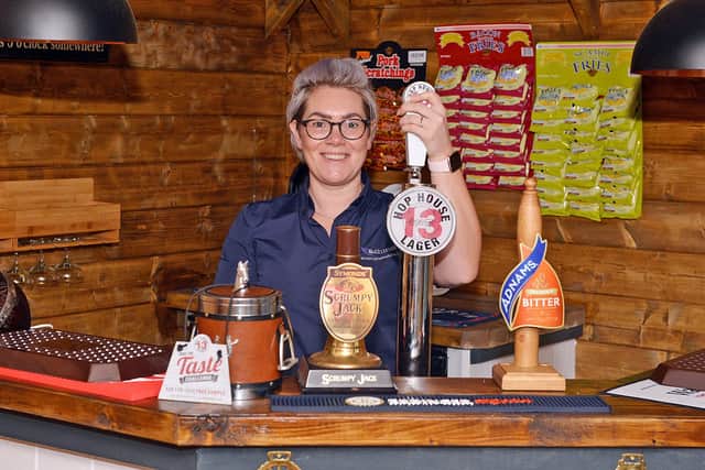 Quality Manager Danielle Cotton pulls a pint at the visitor  pub pod the Ashmere Arms - on the Ashmere Nottinghamshire Ltd site, Priestsic Road, Sutton in Ashfield