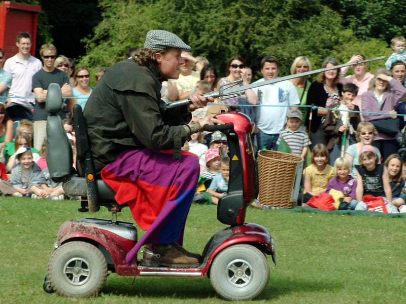 Robin Hood enters the arena on a mobility scooter.