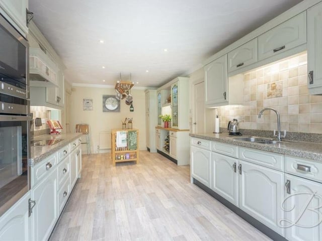 The impressive kitchen comes with a beautiful range of shaker-style wall and base units, and contemporary worktops with inset sink and drainer. Integrated appliances include an eye-level Neff oven and microwave, and hob with extractor fan above.