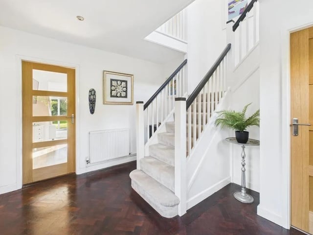 Beautiful and welcoming entrance hallway with dual aspect picture windows, original herringbone parquet flooring and original staircase.