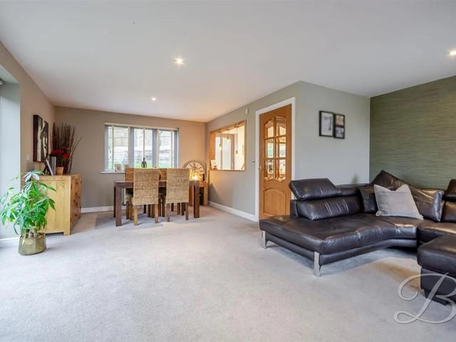 The spacious, bright, and airy living/dining room features windows to the front and rear elevations, as well as patio doors to the side providing access to the garden. Modern in style, this room offers a comfortable and inviting space for relaxation and entertaining with ample space for your desired dining furniture.