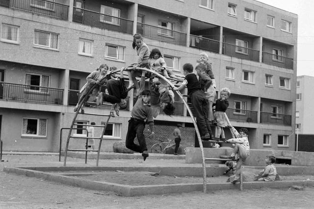 Murrayfield Estate in Blackburn - children on the bars in a playground.