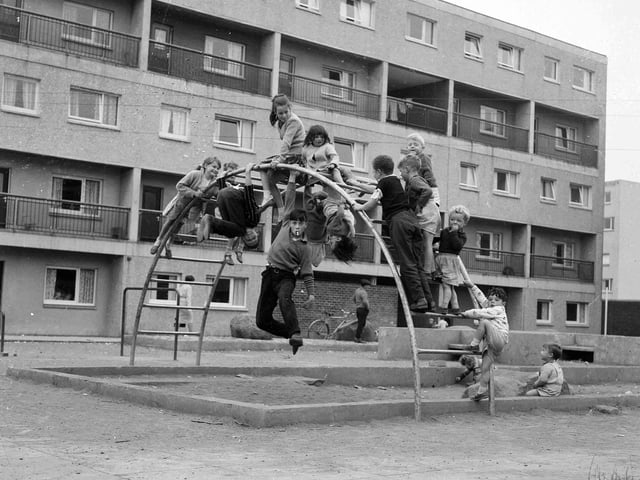 Murrayfield Estate in Blackburn - children on the bars in a playground.