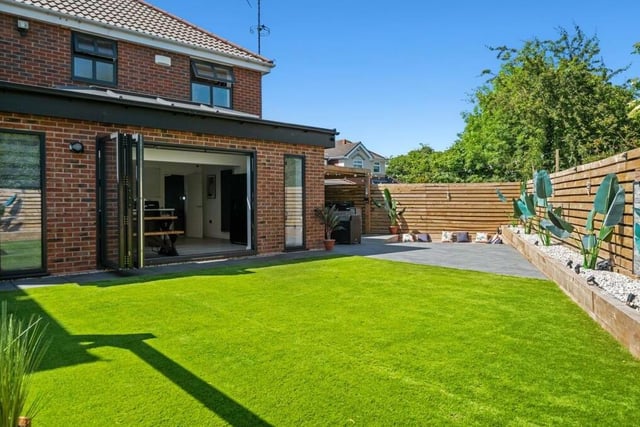 Here's what you get when you step through those bi-folding doors from the kitchen and dining area. A lovely enclosed garden with lawn,