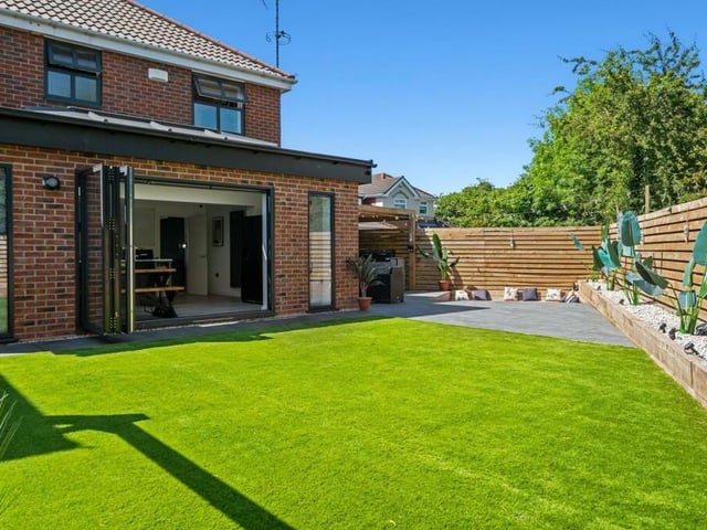 Here's what you get when you step through those bi-folding doors from the kitchen and dining area. A lovely enclosed garden with lawn,