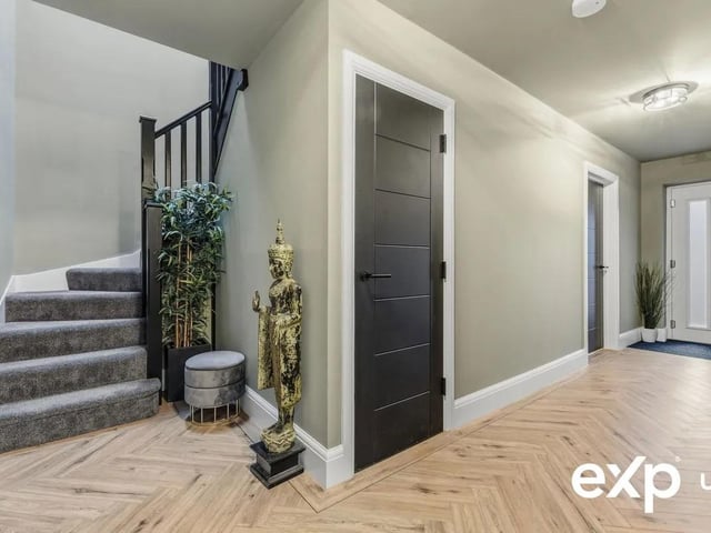 The welcoming reception hall with underfloor heating, a useful storage cupboard, and a staircase to the first floor.