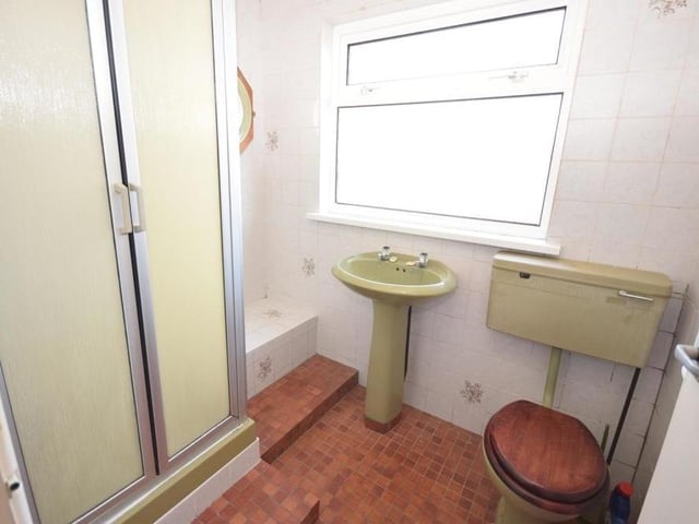 The first floor also houses this second shower room, which comprises a shower cubicle, low-flush WC and wash basin. The floor and walls are tiled.