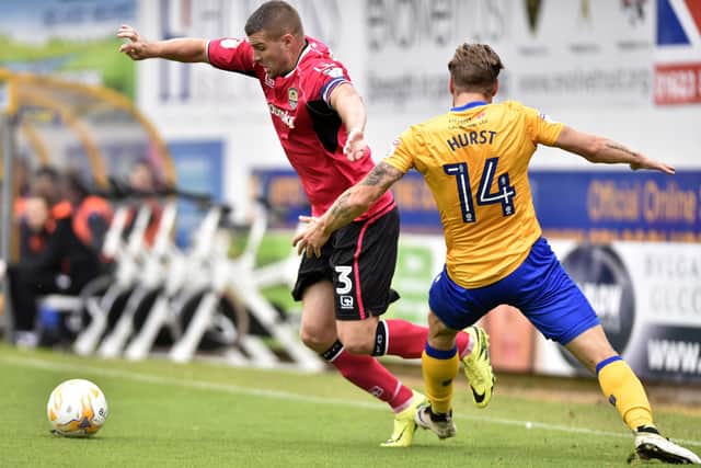Carl Dickinson of Notts County and Kevan Hurst of Mansfield Town during the Sky Bet League Two match between Mansfield Town and Notts County at One Call Stadium on October 8, 2016 in Mansfield, England. (Photo by Nathan Stirk/Getty Images)