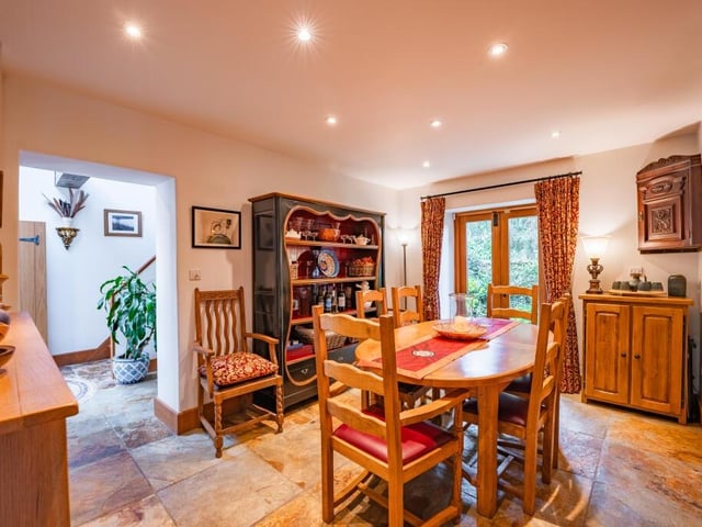 The formal dining room is a beautiful space, featuring a slate tiled floor and patio doors that allow access to a courtyard garden, tucked away at the back of the £1.15 million property.